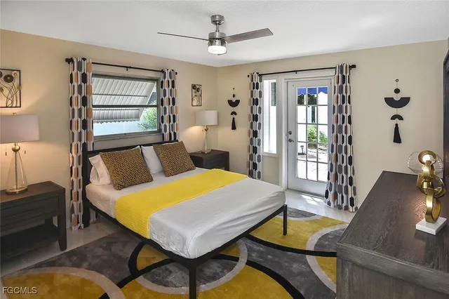 a living room with furniture a table and chairs next to large window