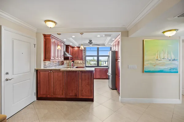 a kitchen with stainless steel appliances granite countertop wooden cabinets and a stove top oven