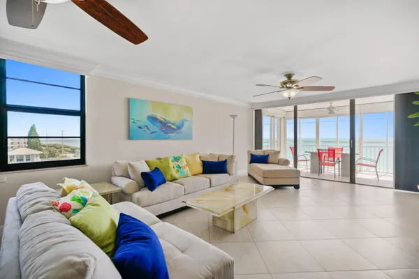 a living room with furniture and a ceiling fan