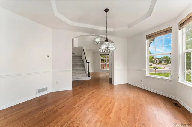 a kitchen with stainless steel appliances granite countertop a sink a stove and refrigerator