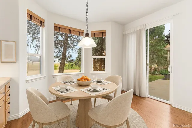 a large kitchen with stainless steel appliances granite countertop a stove and a wooden floors
