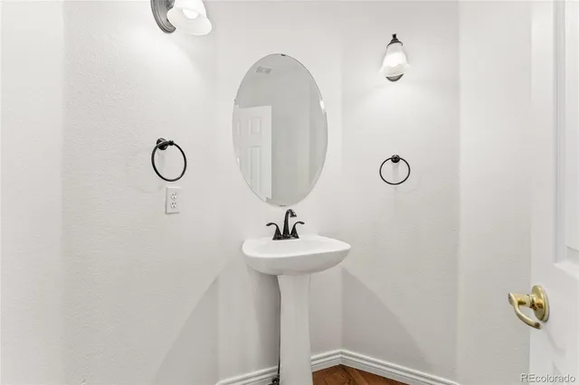 an empty room with wooden floor and a window