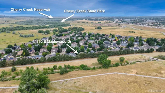 a view of swimming pool with lounge chair in front of house