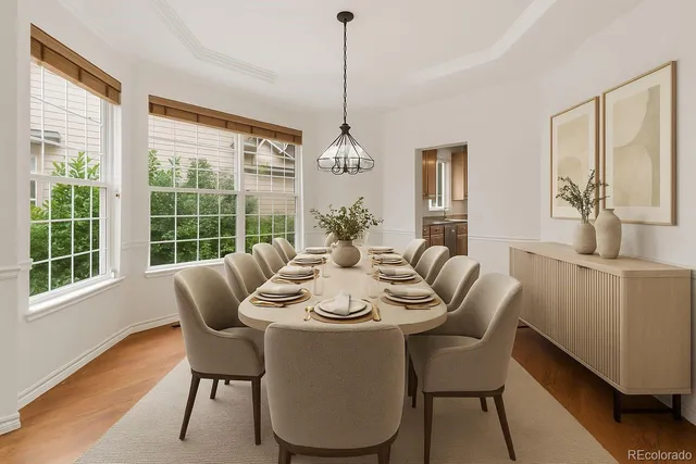 a dining room with furniture a chandelier and wooden floor