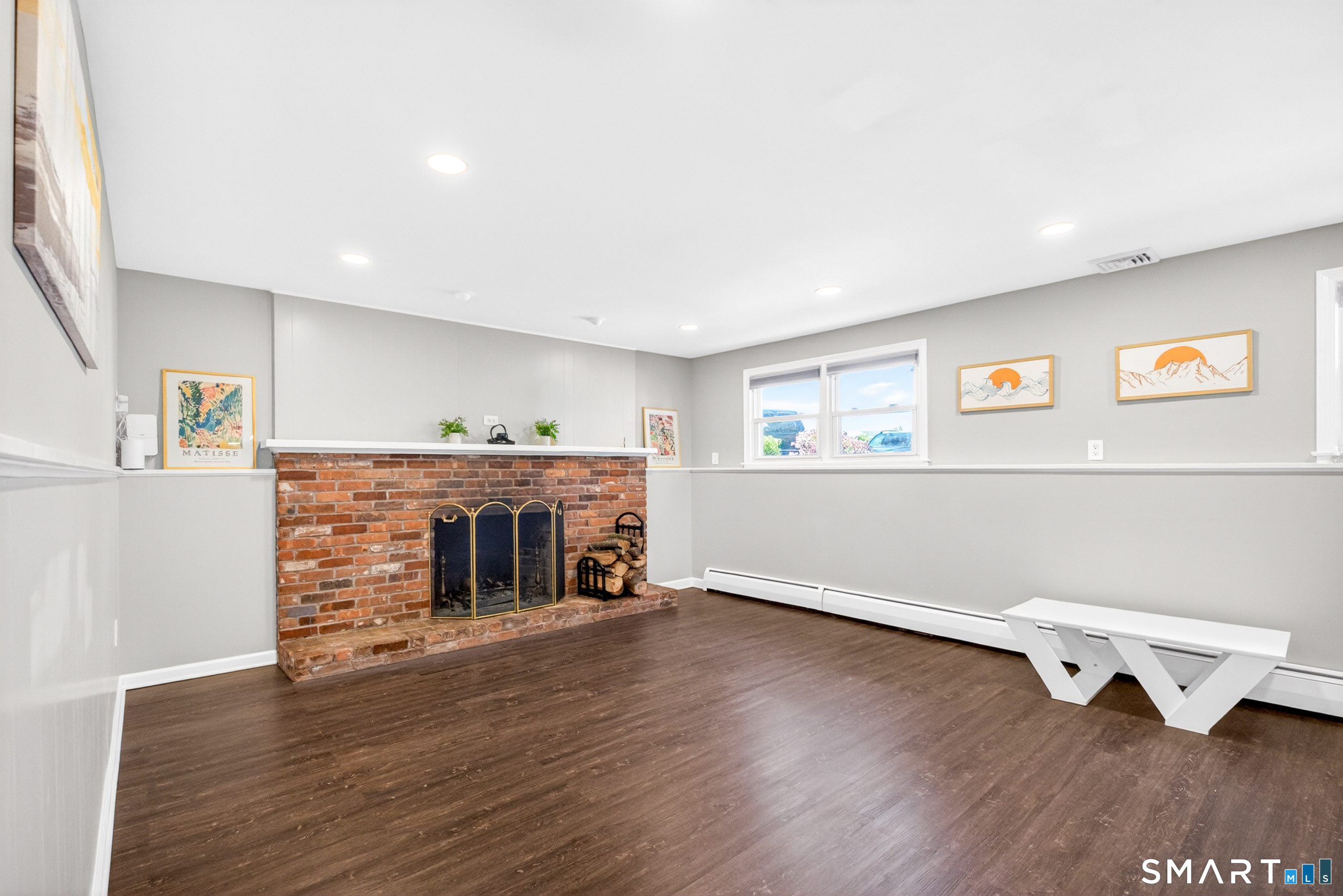 568 Wiese Road Cheshire, CT 06410 - Photo 16 of 40 a view of empty room with wooden floor and fireplace