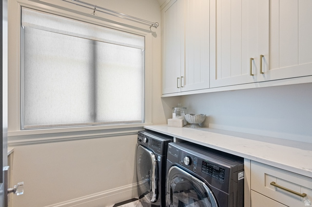 3 Carriagewood Cove, Unit 1088 Sandy, UT 84092 - Photo 25 of 79 Laundry area featuring a window with roller shades, light-toned upper cabinetry with gold-finish hardware, a built-in countertop, and under-counter appliances