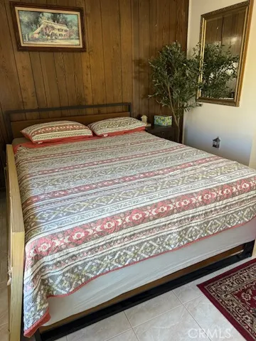 a bedroom with a bed and a potted plant