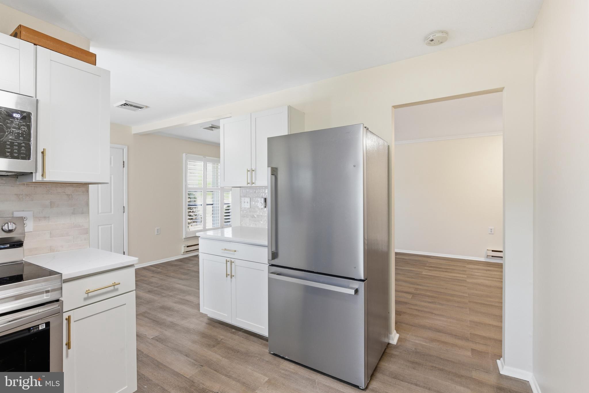 43B Magnolia Road Manahawkin, NJ 08050 - Photo 9 of 26 a kitchen with stainless steel appliances a refrigerator and a stove top oven