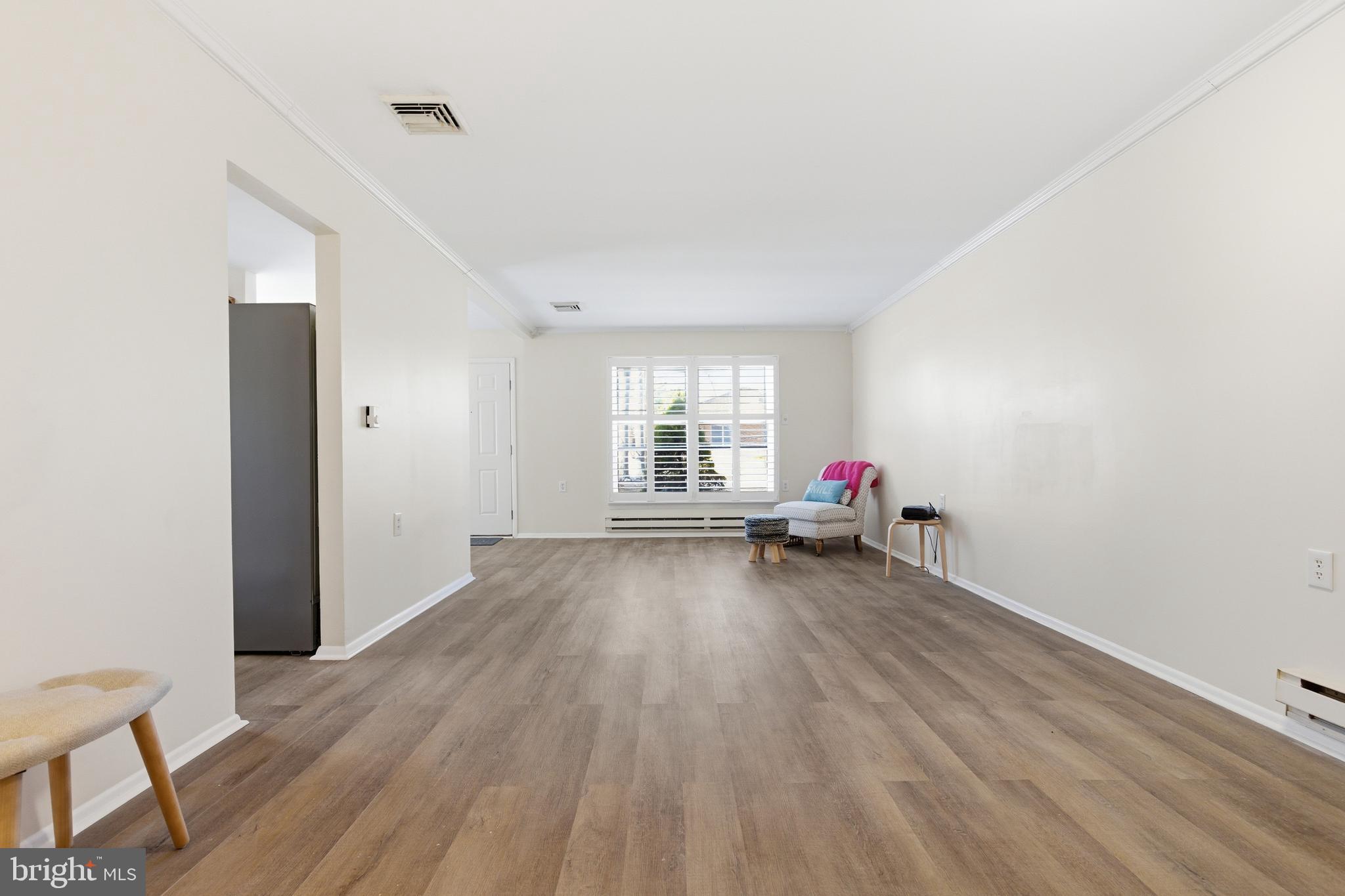 43B Magnolia Road Manahawkin, NJ 08050 - Photo 10 of 26 a view of a livingroom with wooden floor and white walls