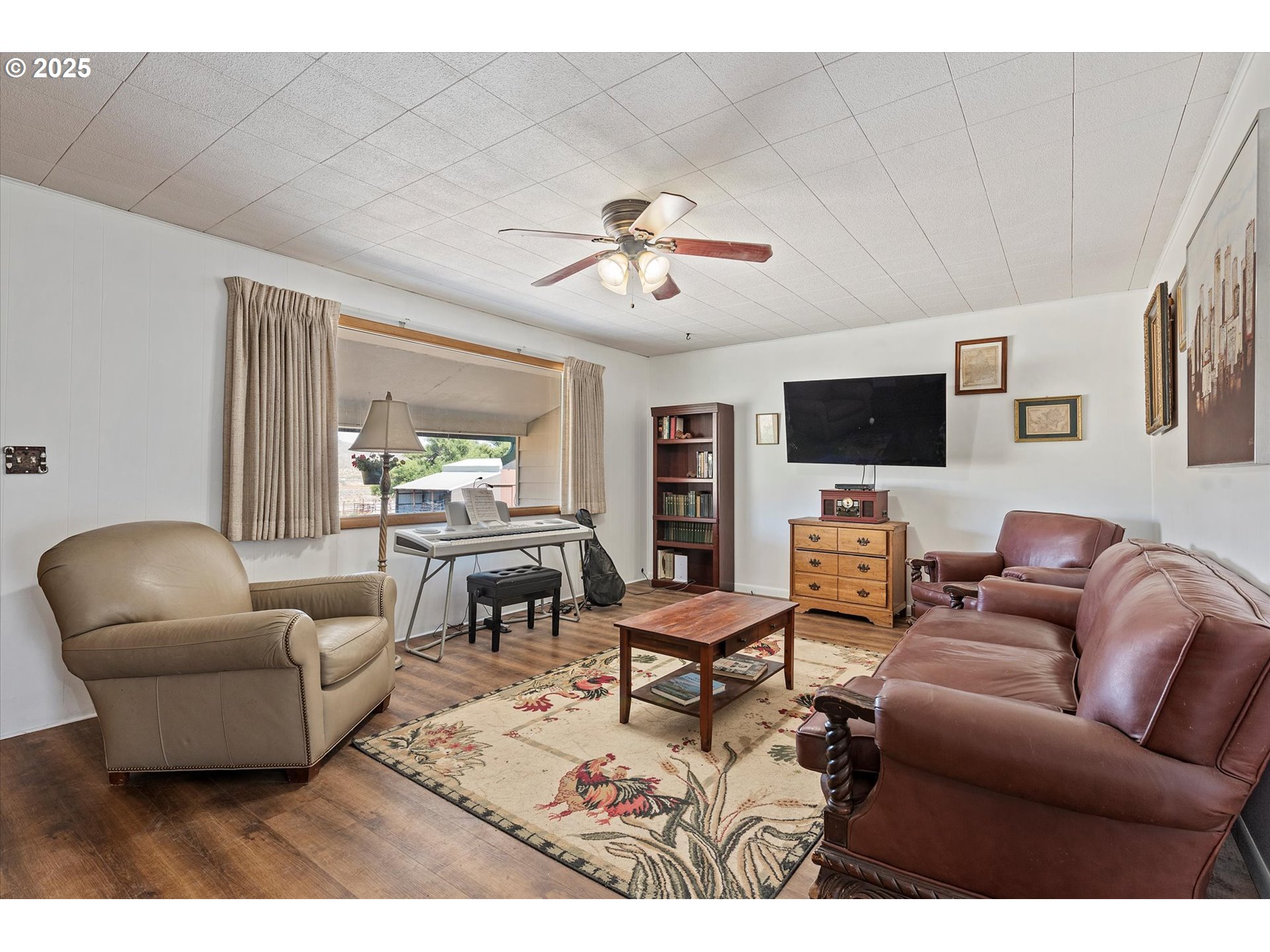 37799 Alder Creek Road Baker City, OR 97814 - Photo 2 of 41 a living room with furniture a flat screen tv and kitchen view