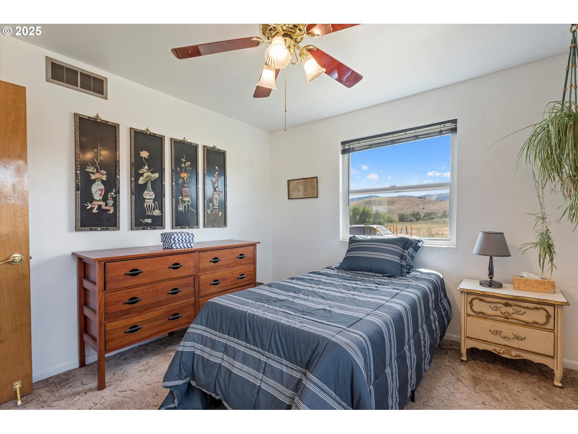 37799 Alder Creek Road Baker City, OR 97814 - Photo 22 of 41 a bedroom with a bed and a chandelier
