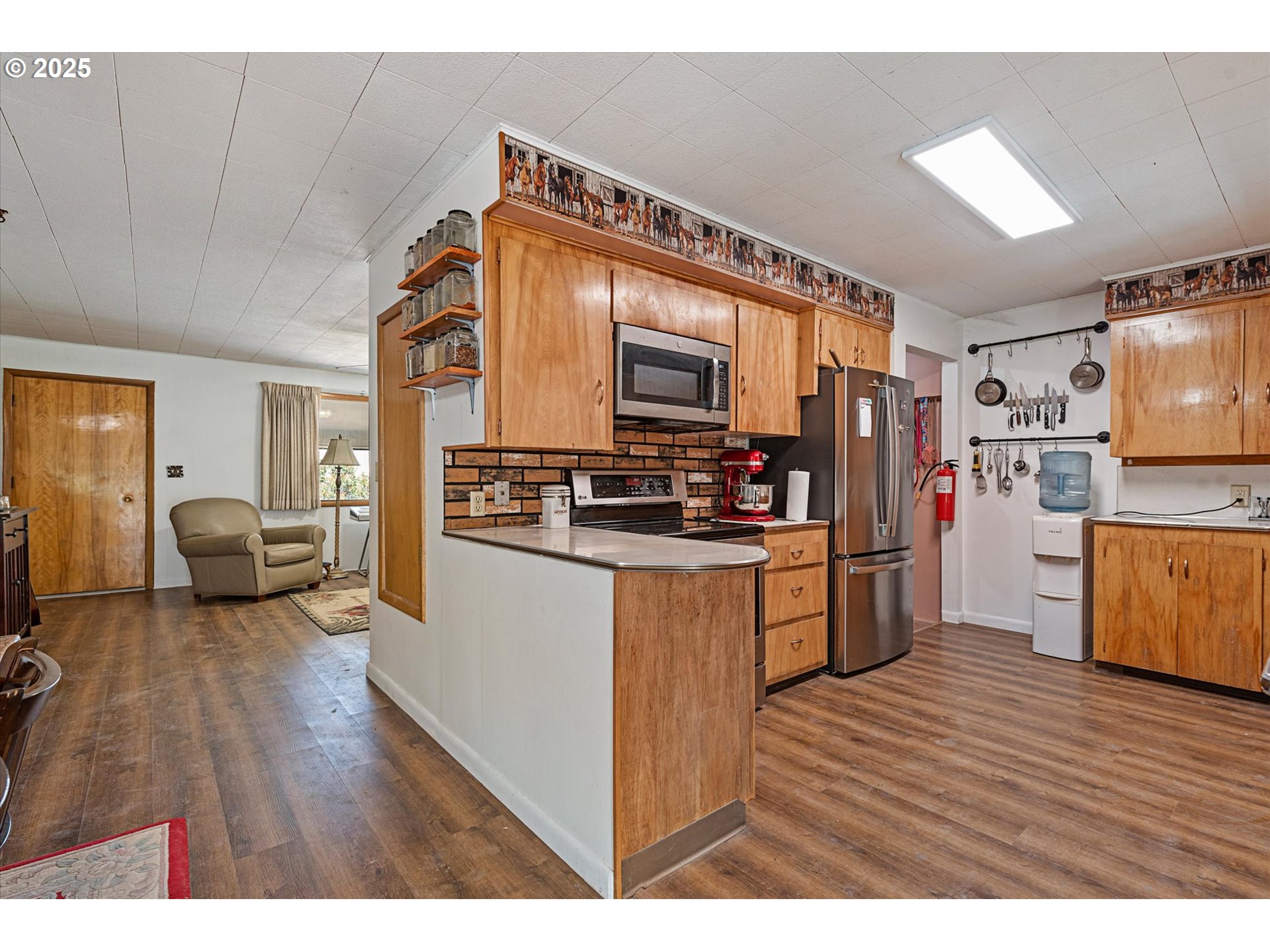 37799 Alder Creek Road Baker City, OR 97814 - Photo 8 of 41 a kitchen with stainless steel appliances kitchen island granite countertop a refrigerator a stove and a wooden floors