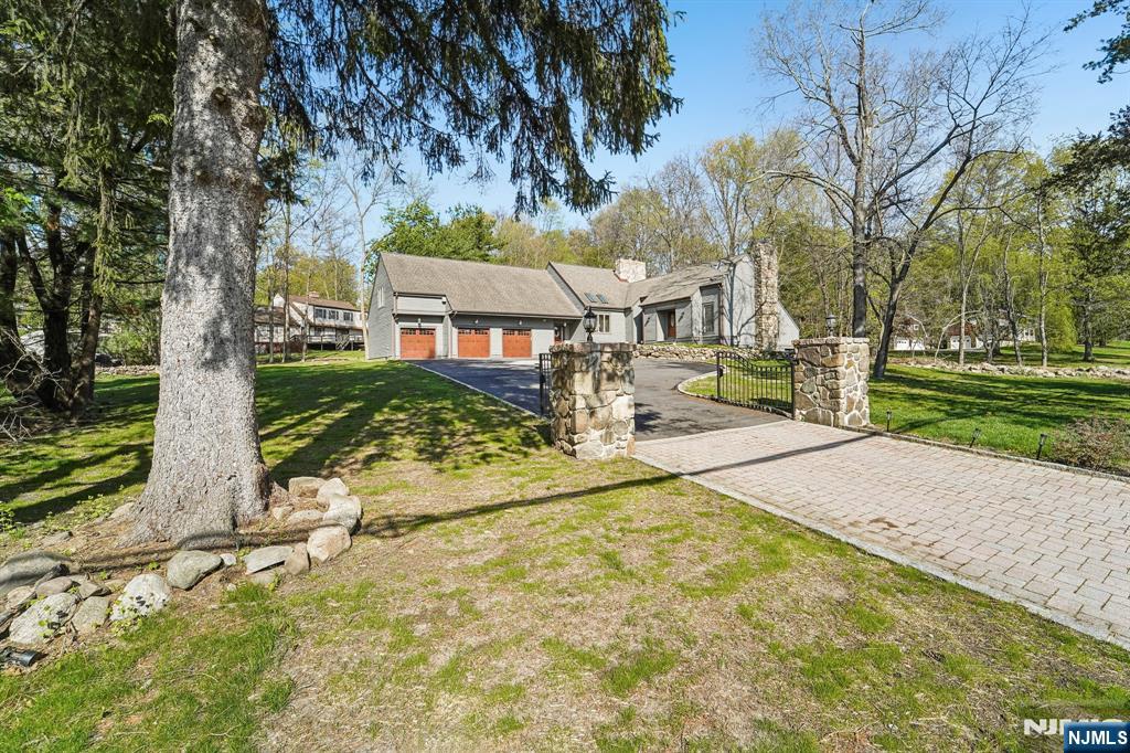11 Carlough Road Upper Saddle River, NJ 07458 - Photo 1 of 41 a front view of a house with a yard and trees