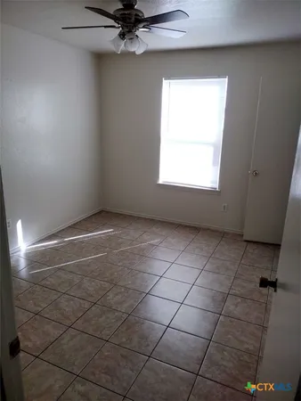 a view of an empty room and a window