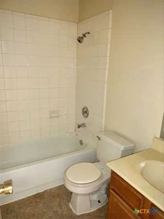 a bathroom with a toilet a sink and shower