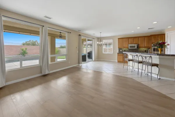 a view of a living room kitchen and a wooden floor