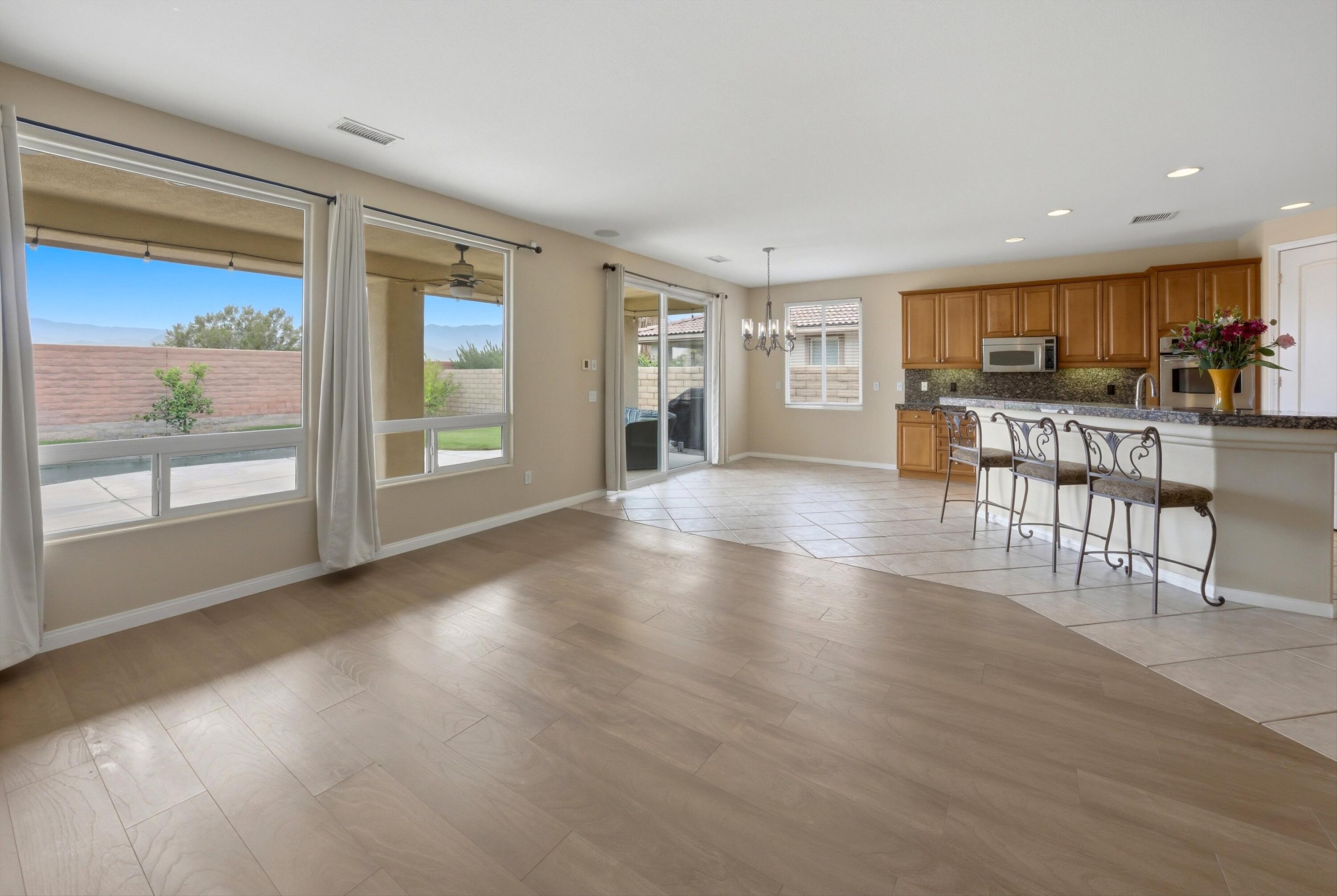 232 Via Firenza Rancho Mirage, CA 92270 - Photo 11 of 43 a view of a living room kitchen and a wooden floor