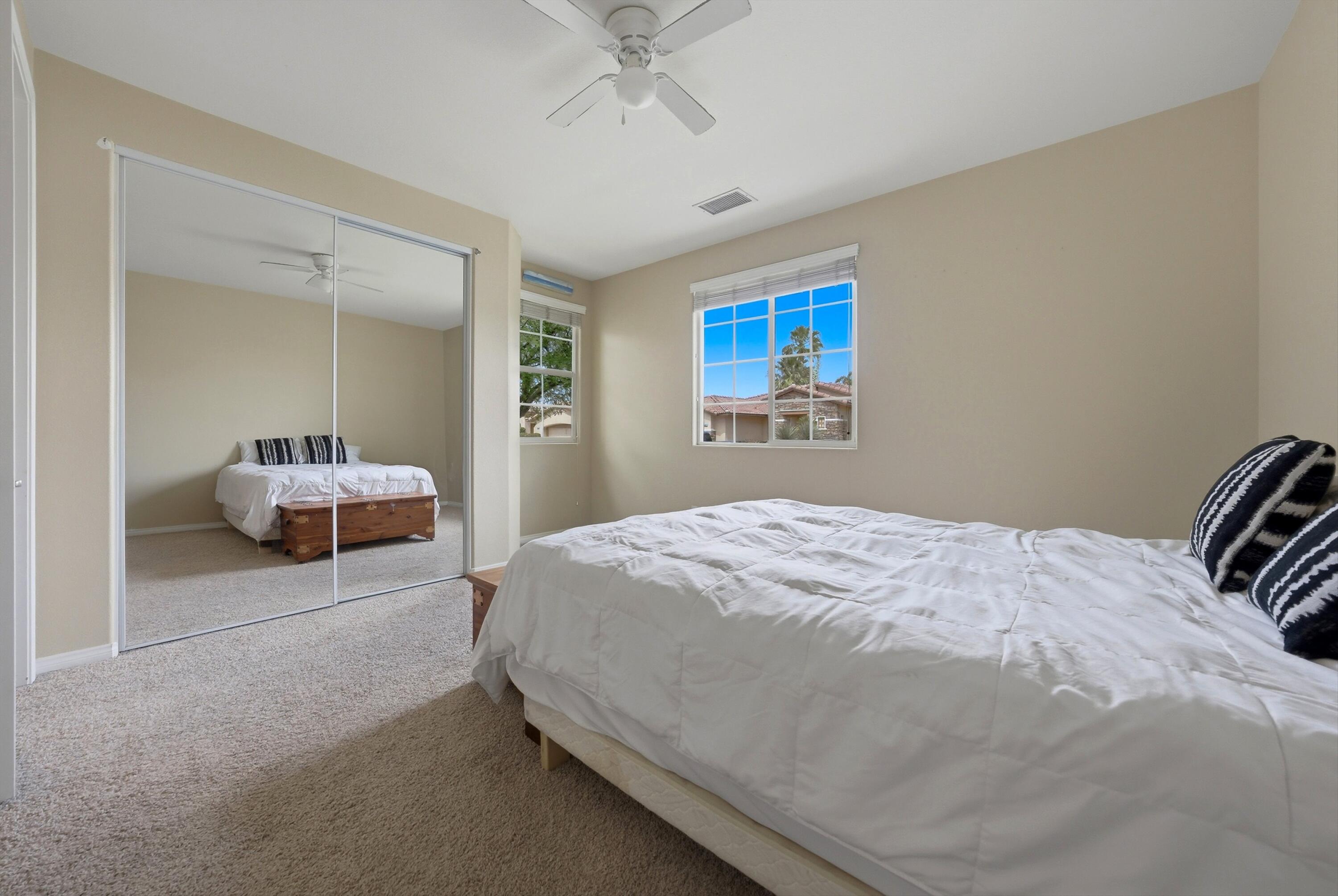 232 Via Firenza Rancho Mirage, CA 92270 - Photo 17 of 43 a bedroom with a bed and a chandelier
