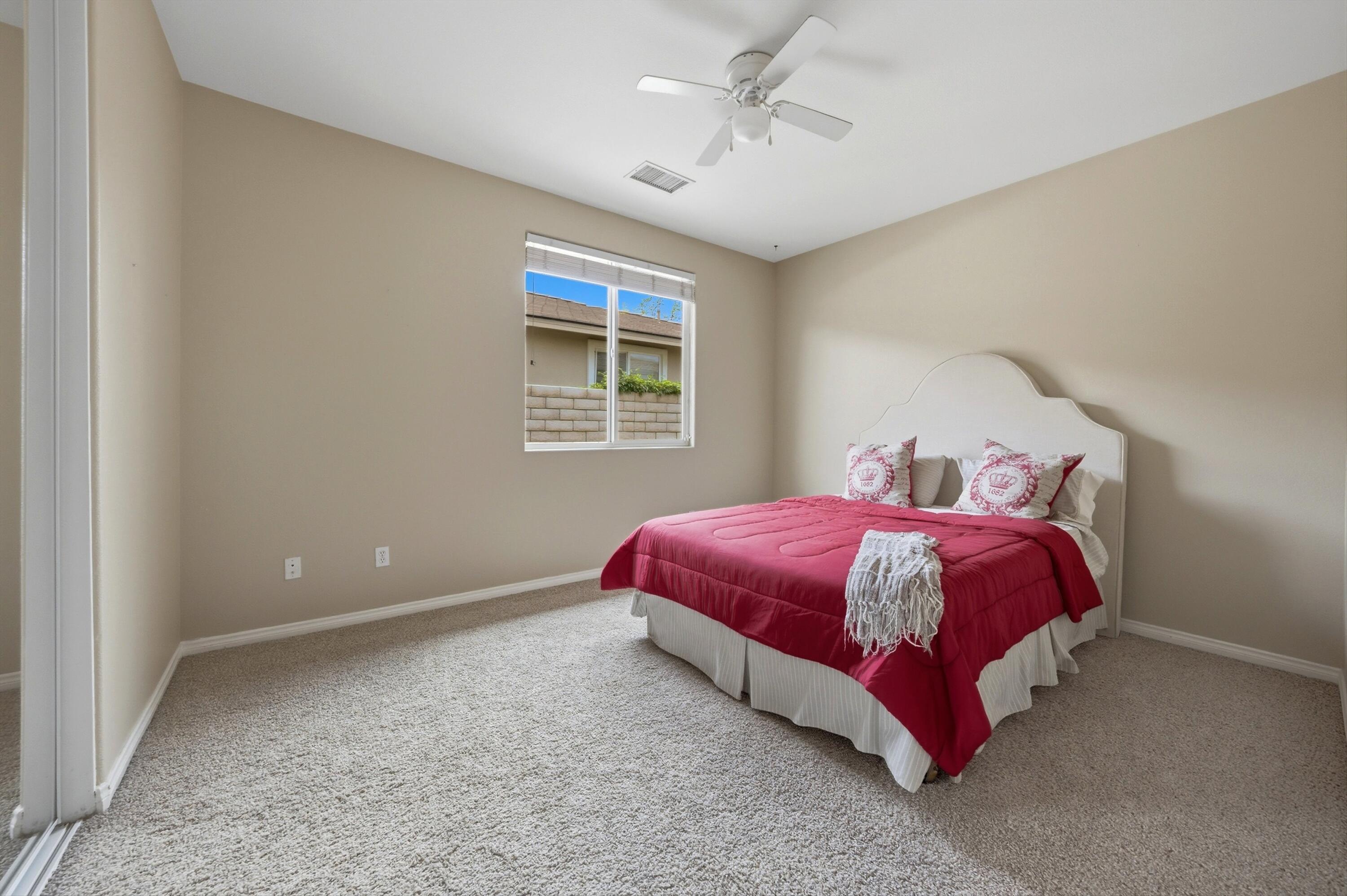 232 Via Firenza Rancho Mirage, CA 92270 - Photo 21 of 43 a spacious bedroom with a bed and a window