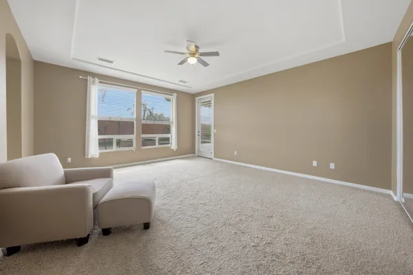 a living room with furniture and ceiling fan