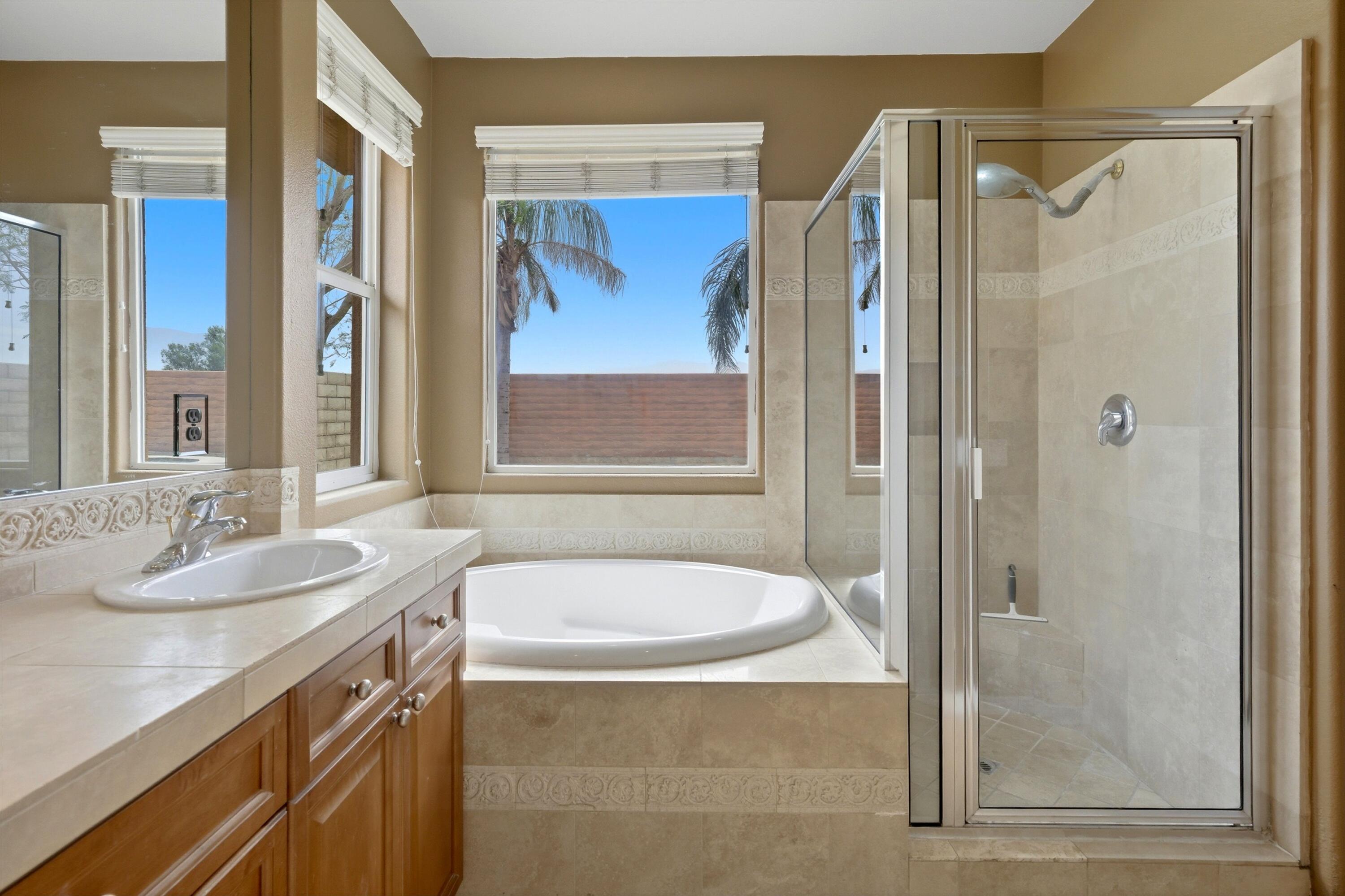 232 Via Firenza Rancho Mirage, CA 92270 - Photo 25 of 43 a bathroom with a granite countertop sink toilet and shower