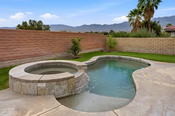 a view of a swimming pool with lounge chair