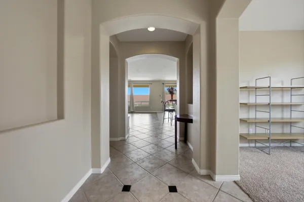a view of a hallway with wooden shelves