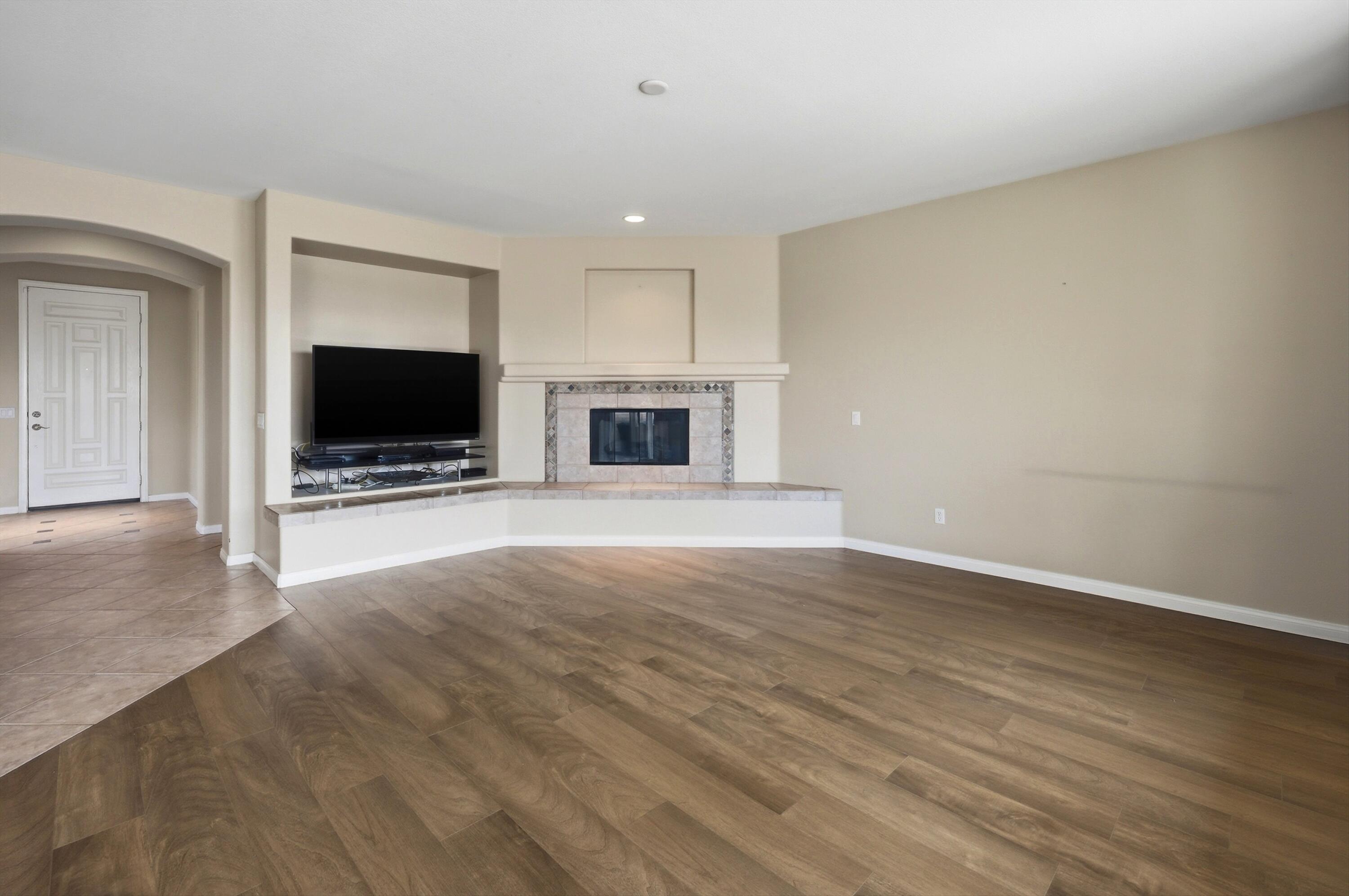 232 Via Firenza Rancho Mirage, CA 92270 - Photo 9 of 43 a view of empty room with wooden floor and fireplace