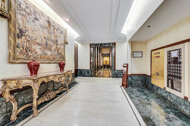 a spacious bedroom with a large bed and a dresser