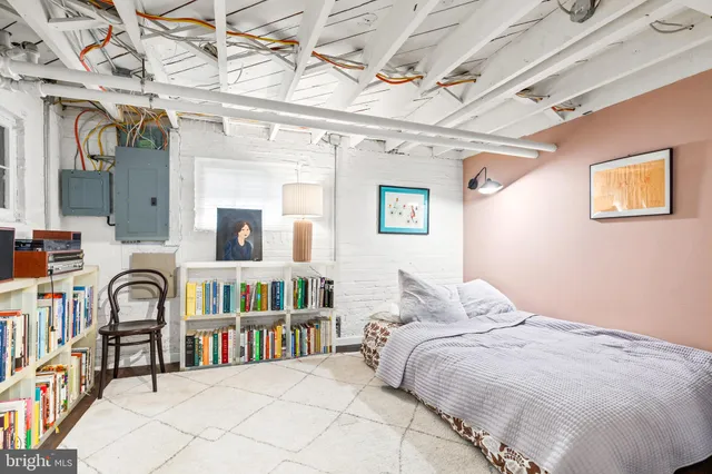 a bedroom with a bed next to a book shelf