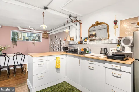 a kitchen with a sink appliances and cabinets