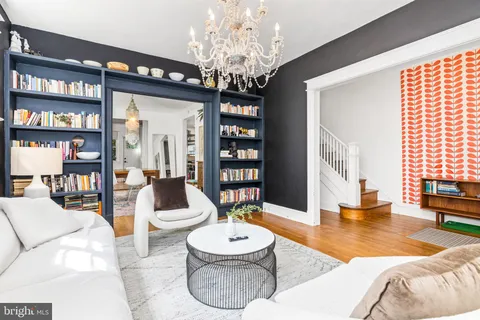 a living room with furniture and a chandelier