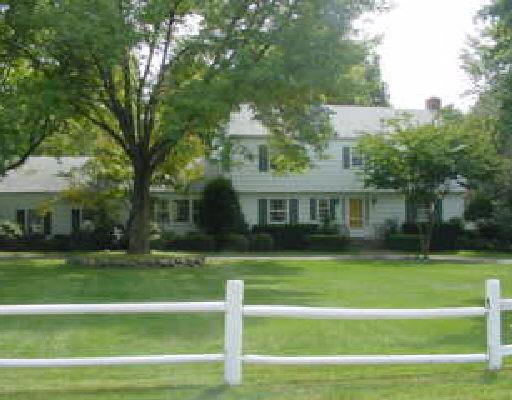 18 High Acre Road Weston, CT 06883 - Photo 1 of 1 a view of a white house in a big yard with large trees