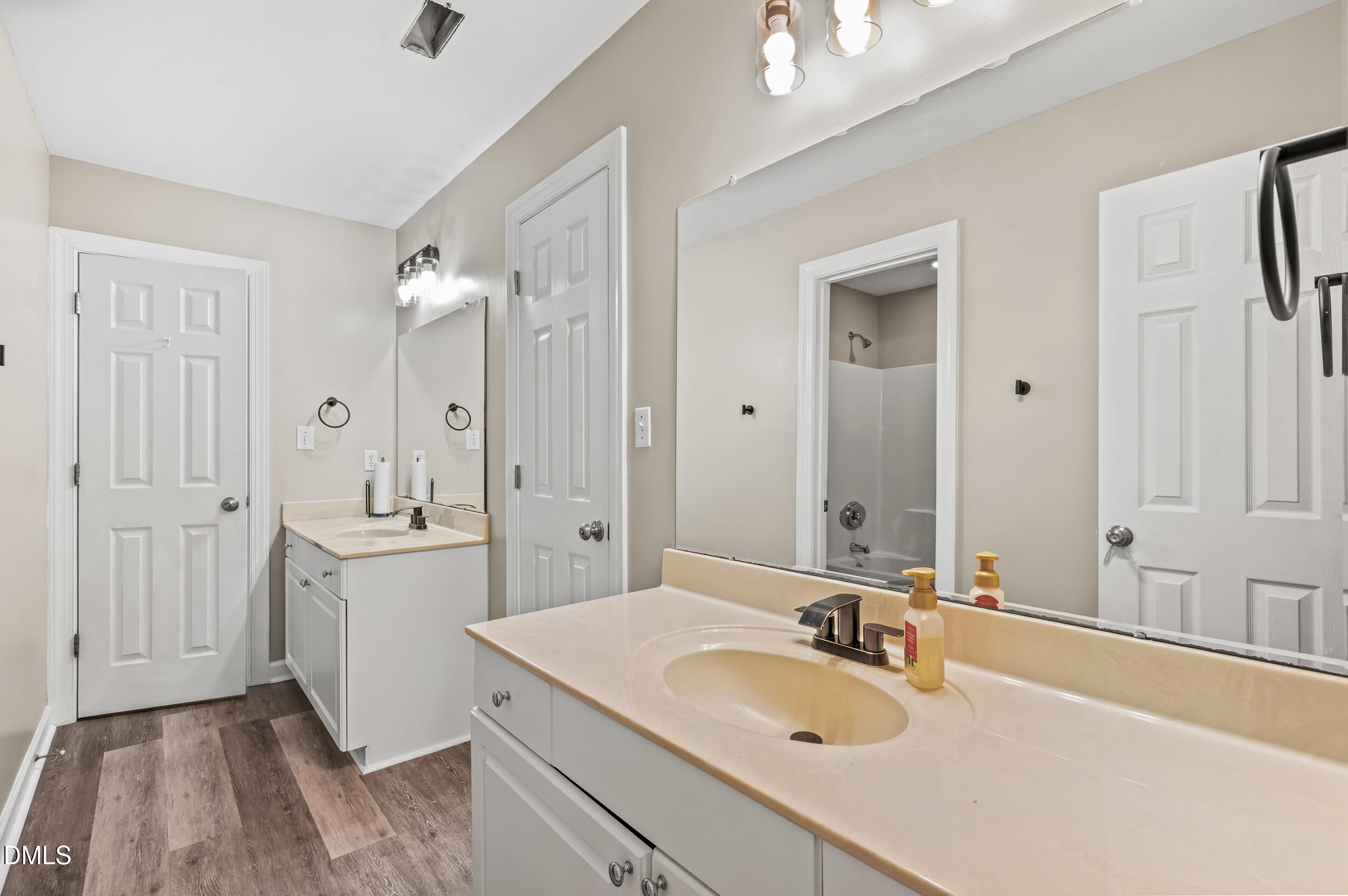 1957 Hilltop Road Raleigh, NC 27610 - Photo 24 of 46 a bathroom with a granite countertop double vanity sink a mirror and a bathtub