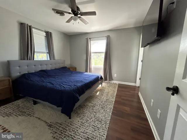 a spacious bedroom with a bed and window