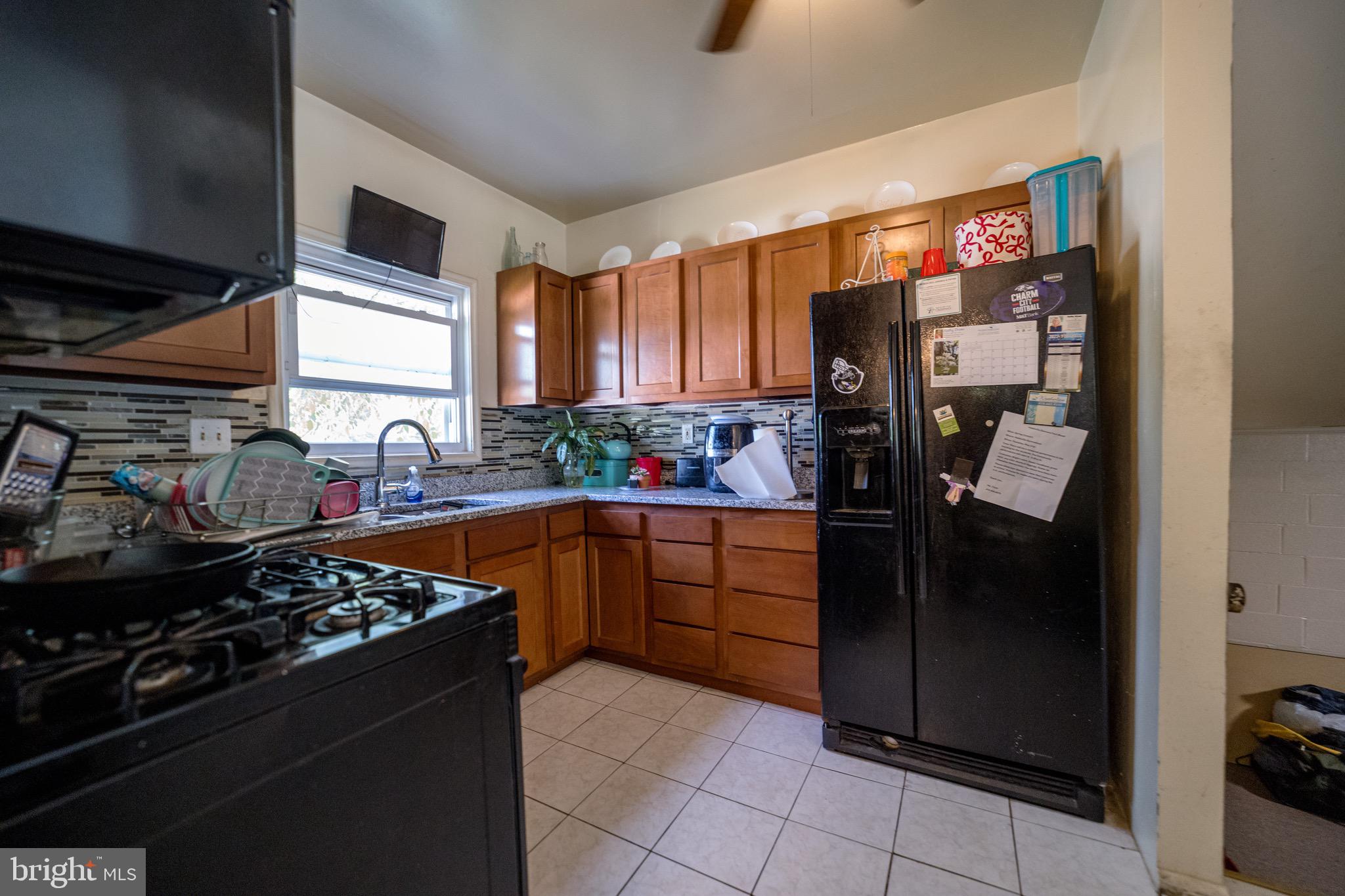 4125 Ronis Road Pikesville, MD 21208 - Photo 35 of 40 a kitchen with stainless steel appliances granite countertop a stove and a refrigerator