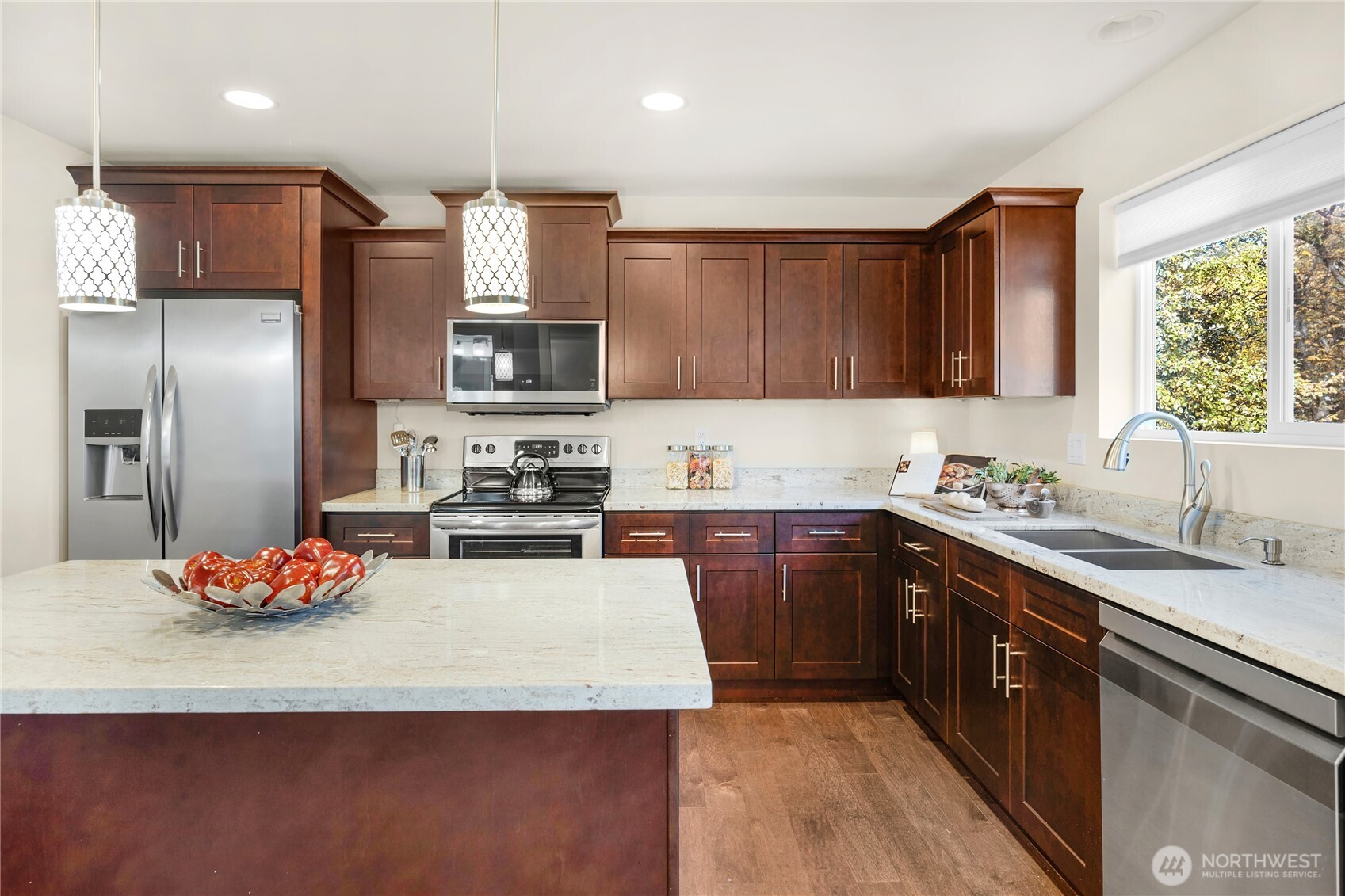10034 59th Avenue South Seattle, WA 98178 - Photo 15 of 39 a kitchen with stainless steel appliances granite countertop a sink refrigerator and microwave