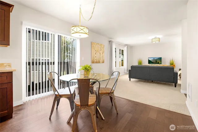 a view of a dining room with furniture and chandelier