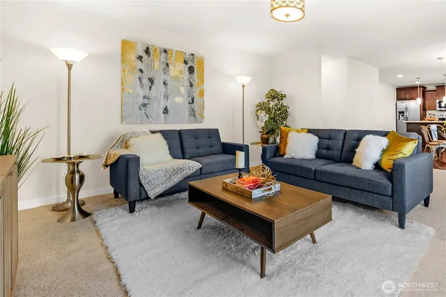 a living room with furniture a rug and a wall painting