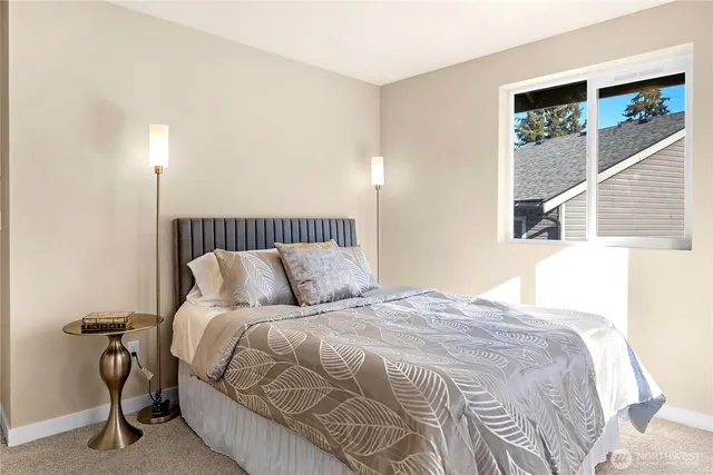 a bedroom with a bed and a window