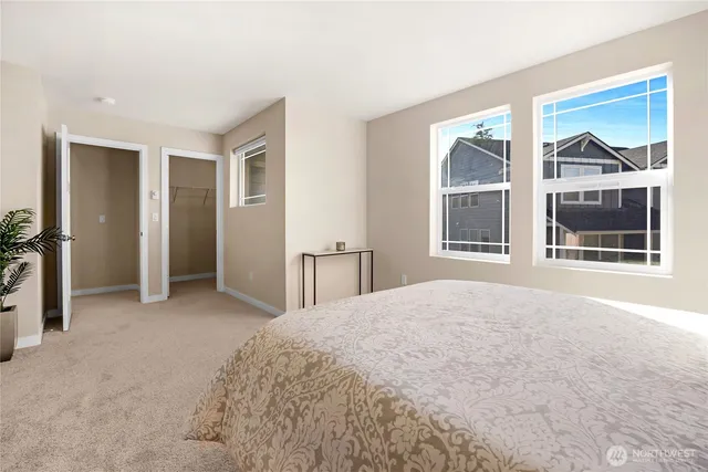 a view of empty room with windows and wardrobe