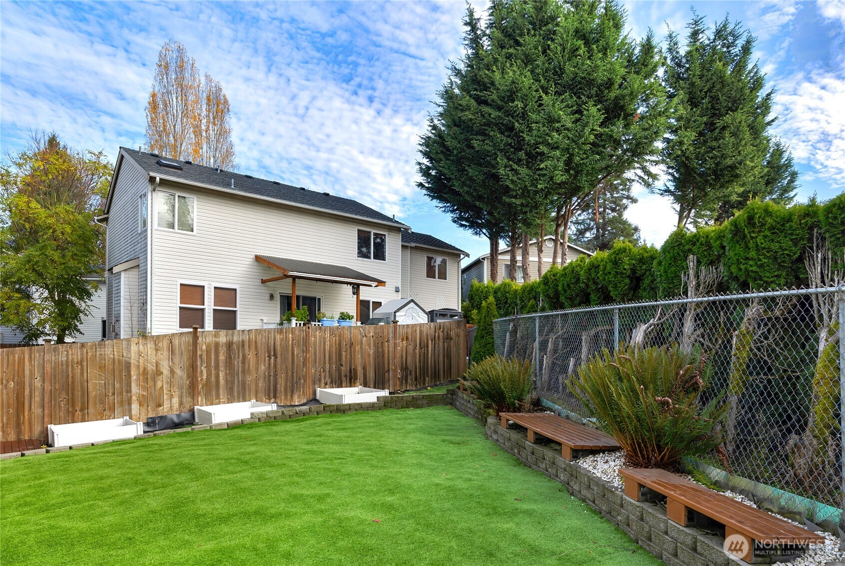 10034 59th Avenue South Seattle, WA 98178 - Photo 38 of 39 a view of a backyard with plants and wooden fence