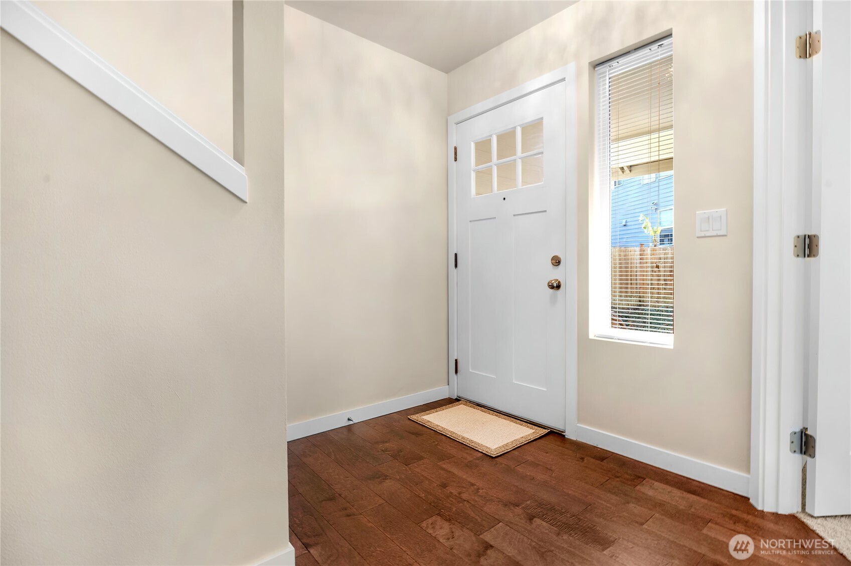 10034 59th Avenue South Seattle, WA 98178 - Photo 5 of 39 a view of a bedroom with wooden floor and windows