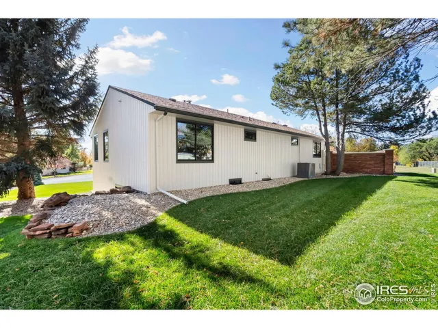 a aerial view of a house with a garden and lake view