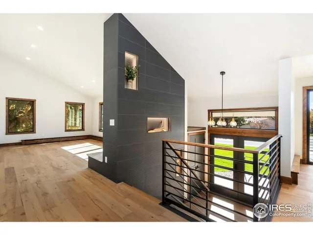 a view of a hallway with wooden floor and furniture