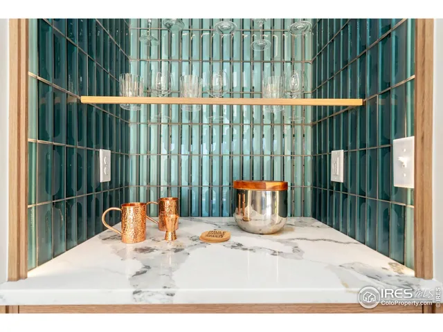 a kitchen with stainless steel appliances kitchen island granite countertop a stove a sink a dining table and chairs