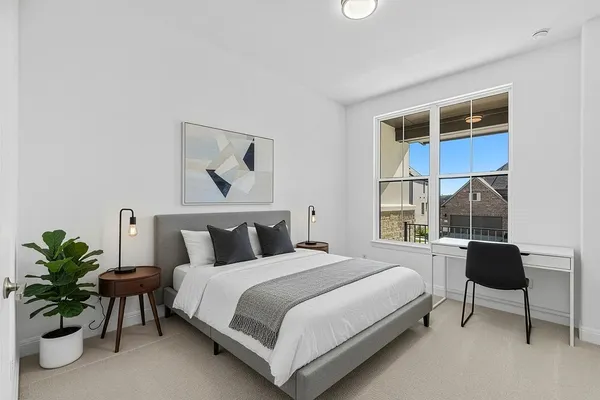 a bedroom with a bed and a potted plant