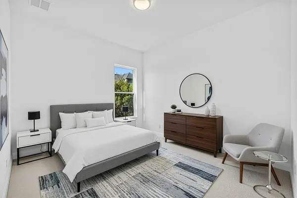 a bedroom with a bed a window and a dresser