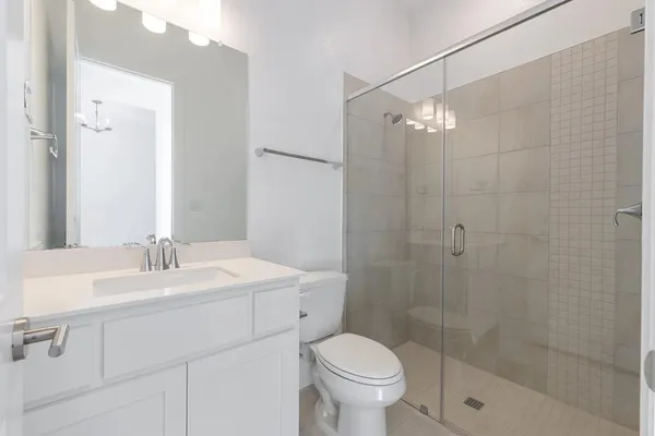 a bathroom with a sink toilet a mirror and shower