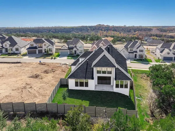 an aerial view of a house with a big yard